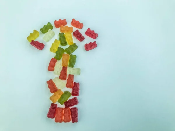 Arrow in the form of multi-colored and bright gummy bears. gelatinous delicious dessert. an appetizing treat for children and adults. the direction of the road in creative and creative expression — Stock Photo, Image