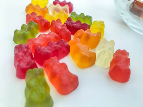 Gelatinous, multi-colored, volumetric bears on a white matte background. mouth-watering and sweet candies. natural edible sweets. dessert made from juices and pomace — Stock Photo, Image