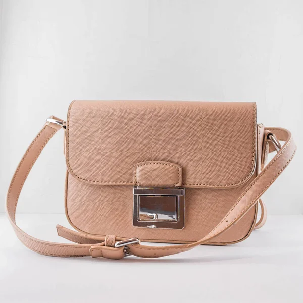 Trendy small woman bag with a long shoulder strap.