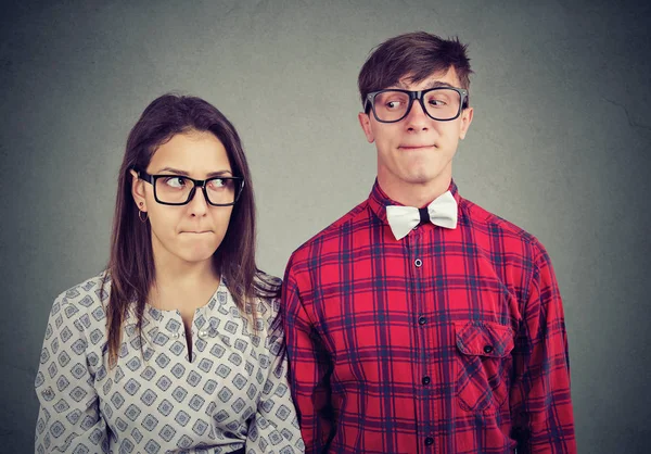 Young man and woman on date feeling awkward being in embarrassed situation