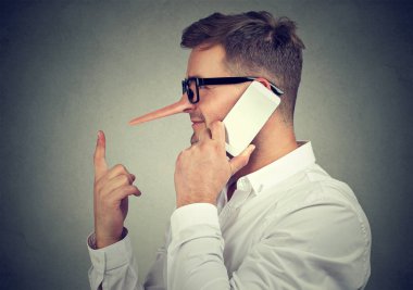 Side view of man with prolonged nose speaking on phone and telling lies on gray background clipart