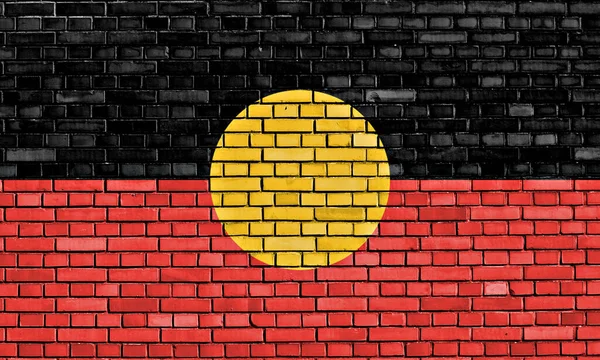 flag of Australian Aboriginal painted on brick wall