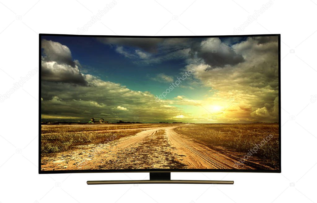 4k monitor isolated on white.  The road is rural, unpaved in the steppes at sunset. Modern, elegant TV 4 K, with incredibly beautiful colors of the image.