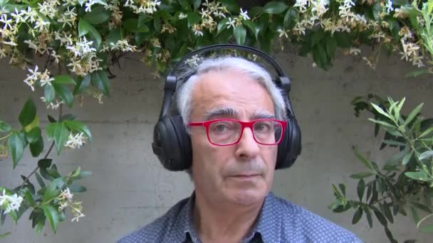 Close Italian European Man Posing While Listening Something Headphones Connected — Stock Video