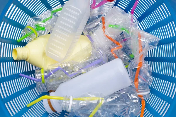 Plastic waste, Plastic bottles with straws in waste basket