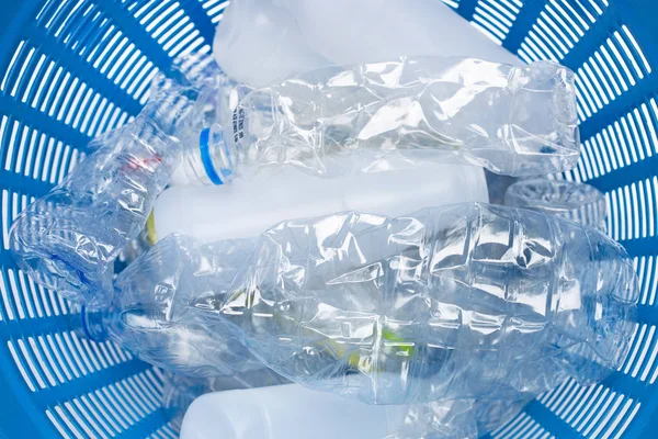 Plastic bottles in waste basket.