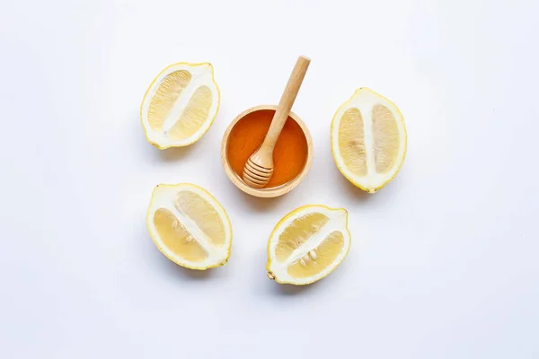 Honey with lemon on white background. Copy space