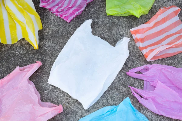 Colorful disposable plastic bags  on cement floor