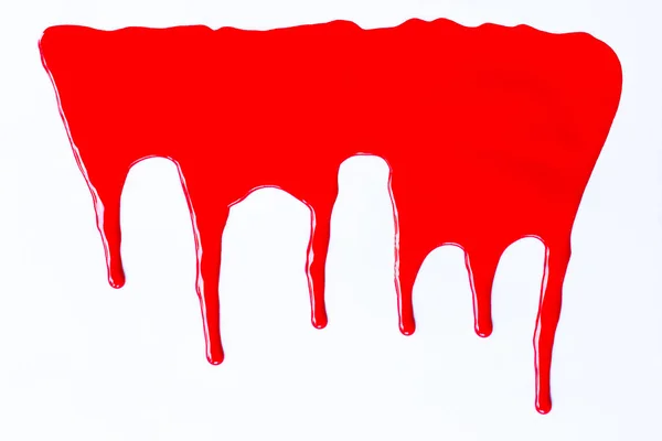 Pintura roja goteando sobre un blanco . — Foto de Stock