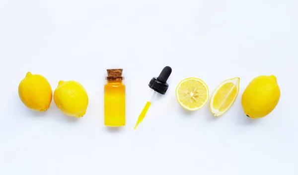 Essential oil with lemon on white. — Stock Photo, Image