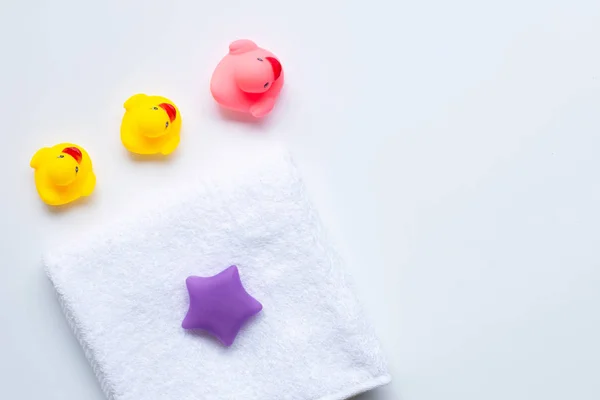 stock image Pink and yellow duck  toys and white towel. Kids bath concept.