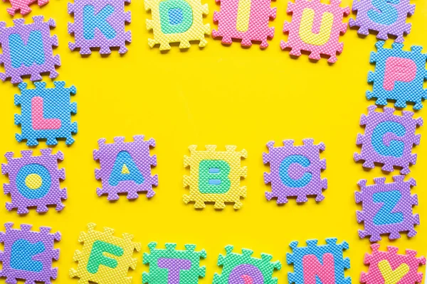 Алфавитная головоломка на жёлтом фоне . — стоковое фото