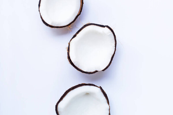 Ripe coconuts on white. Top view of tropical fruit.