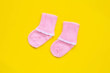 Sarı arka planda bebek çorapları.