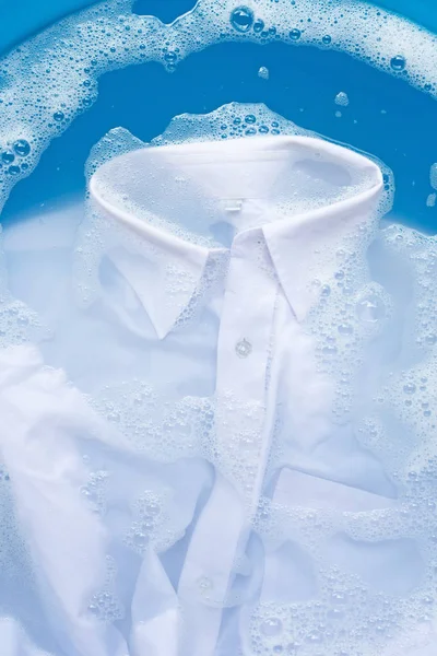 Camisa blanca empapar en polvo detergente disolución de agua. Lavandería — Foto de Stock