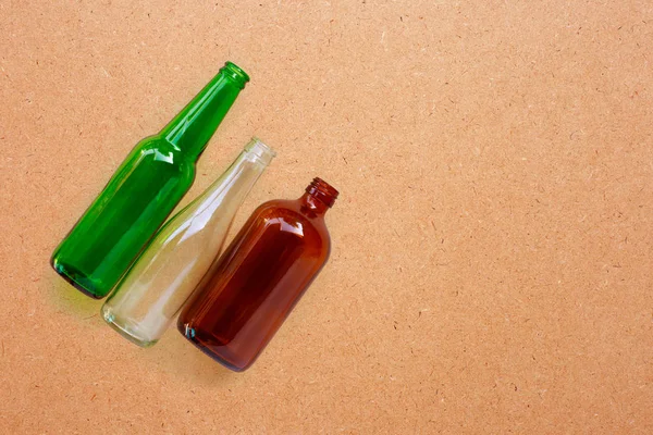 Glass bottles on plywood background. — Stock Photo, Image