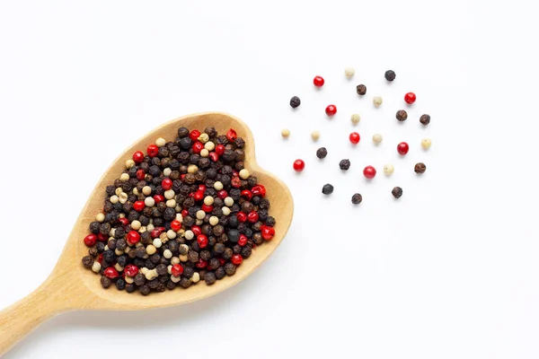 Black, red and white peppercorns with wooden spoon on white — Stock Photo, Image