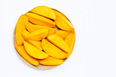 Tropik meyve, beyaz arka planda ahşap tabakta mango dilimleri. Üst görünüm