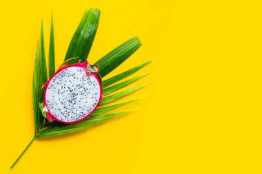 Olgun ejderha meyvesi ya da tropik palmiye yaprakları üzerinde pitahaya. Üst görünüm