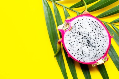 Olgun ejderha meyvesi ya da tropik palmiye yaprakları üzerinde pitahaya. Üst görünüm