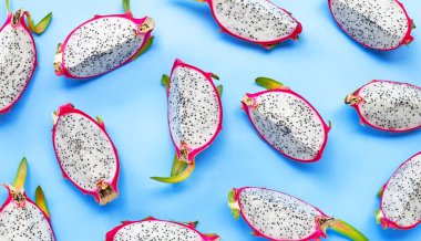 Olgun ejderha meyvesi ya da mavi arka planda pitahaya dilimleri. Üst görünüm