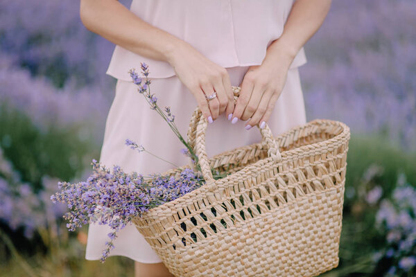 Girl in hand holding bag with lavender