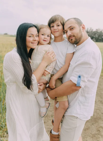 Family in white clothes in a field