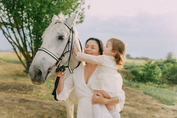 Family in white clothes in a field