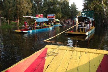 Xochimilco, Mexico City, Mexico - 2019: Trajinera boats fulll of people on a weekend.