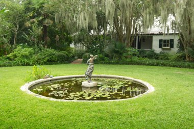 Baton Rouge, Louisiana, USA - 2019: Water lilies on a fountain at the Windrush Gardens museum, located in the grounds of the LSU Rural Life Museum clipart