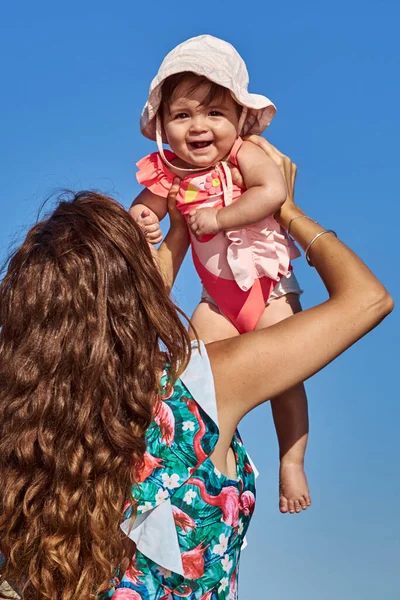 Mamma Tiene Suo Bambino Sulle Mani Sulla Spiaggia Una Soleggiata Foto Stock