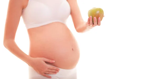 孕妇触摸她的大肚子和拿着苹果的图像 — 图库照片