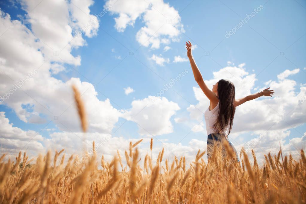 Happy woman enjoying the life in the field. Nature beauty, blue 