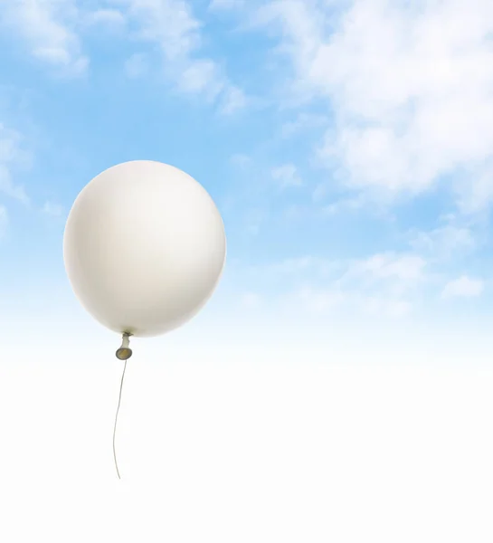 White balloon floating on a blue sky.