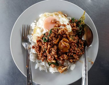 Thai food. Kao Pad Kra Prao or thai rice with pork and egg clipart