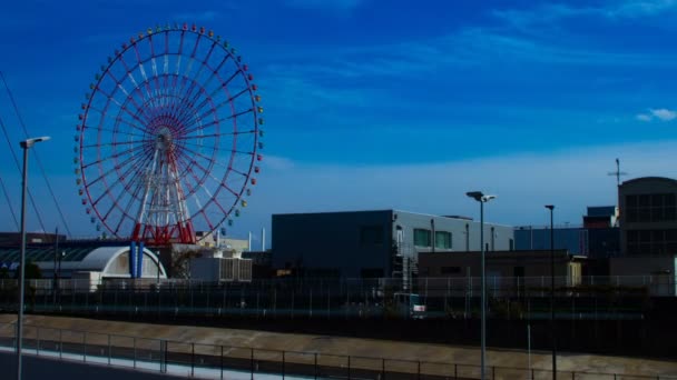 Ferris wheel behind the blue sky — Stock Video
