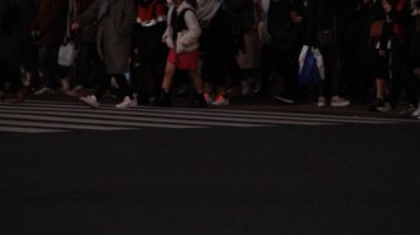 Shibuya geçidinde yürüyen insanların vücut parçaları gece