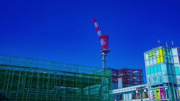 Zeitraffer fahrender Kräne hinter dem blauen Himmel am im Bau befindlichen Standort in Tokio — Stockvideo