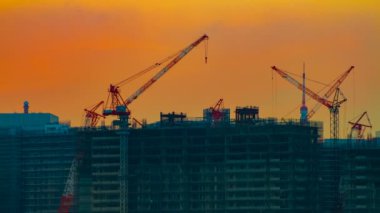 Alacakaranlıkgeniş çekim tokyo'da körfez bölgesinde hareketli vinçler bir zaman atlamalı