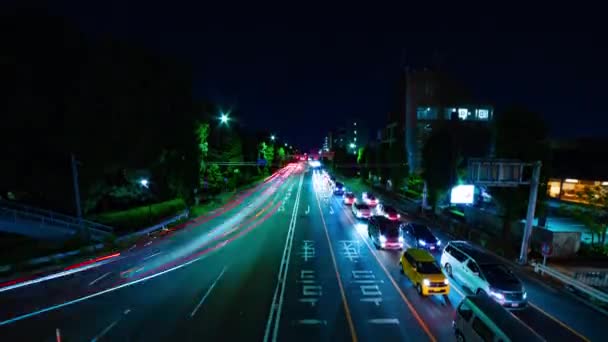 Un lapso de tiempo nocturno de la calle de la ciudad en el centro de Setagaya Tokio tiro ancho — Vídeo de stock