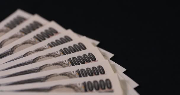 Japonská měna 100,000 jenů na černém pozadí náklonu — Stock video