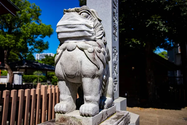 A statue of Guardian dog wearing mask at Meguro fudo temple in Tokyo — Stock Photo, Image