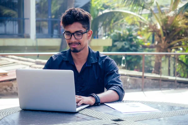 Indian Asian college student studying freelancer working with a laptop on the beach summer cafe .freelance and remote work.businessman at veranda balcony — Stock Photo, Image