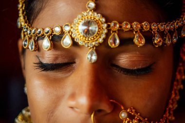 altın zengini mücevher ve gelenek saree yüz portre hint güzel kadın başında bindi giyen yakın çekim profesyonel makyaj . Müslüman Kadın bindis maang tikka ile portre yüz , nath, burun Pin