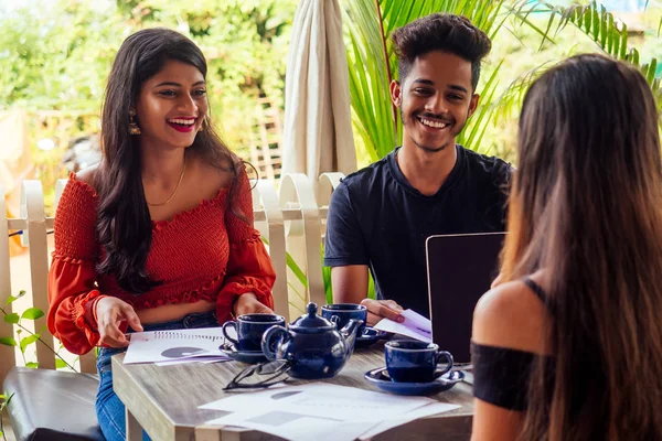 indian partners shaking hands after meeting.businesswoman and businessman at work in summer cafe