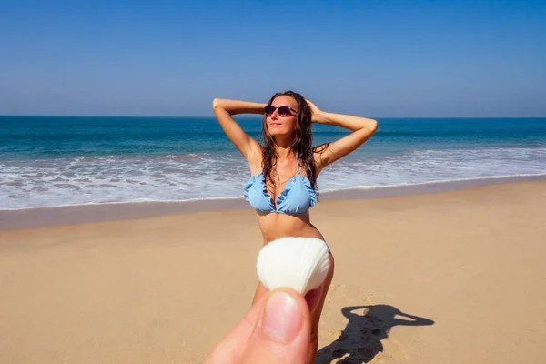 Sexy brunette hair woman hands up blue swimsuit large conch shell chest, pov prospective - man holding seashells covering her bikini area epilation removal of unwanted hair pubic pussy — Zdjęcie stockowe
