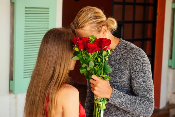 romance marriage proposal by the sea tropical paradise beach beachfront restaurant.blond man and a beautiful blonde female in red dress sitting summer cafe,rose Happy Valentine The 14th of February