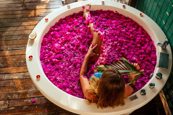 relaxing in bath tropical flowers at luxury hotel resort
