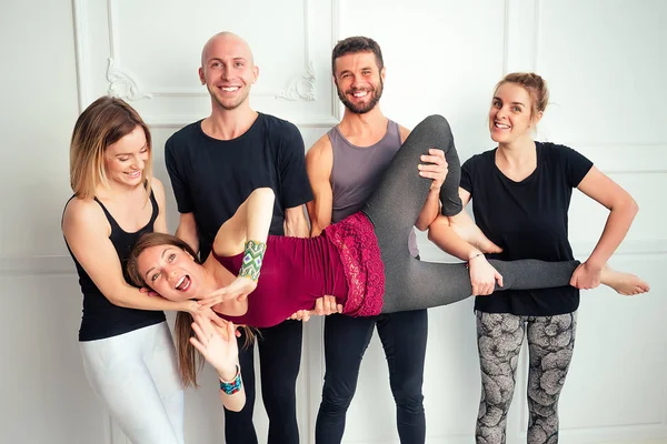 happy group of people from men and women practicing yoga in fun in the studio. groups of meditation and support in the yoga class. yoga, mate, man, woman, many people