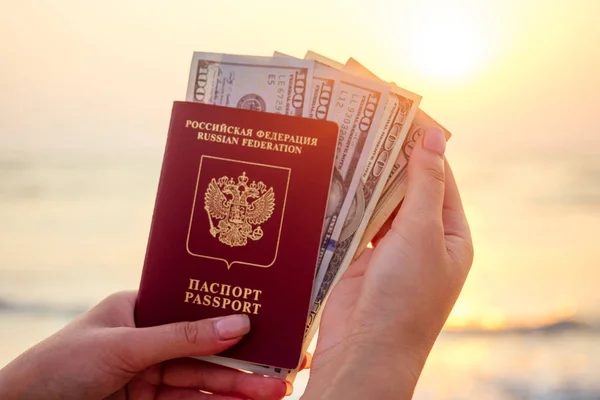 Passport and money in hand on the background of the sea. concept of recreation and tourism